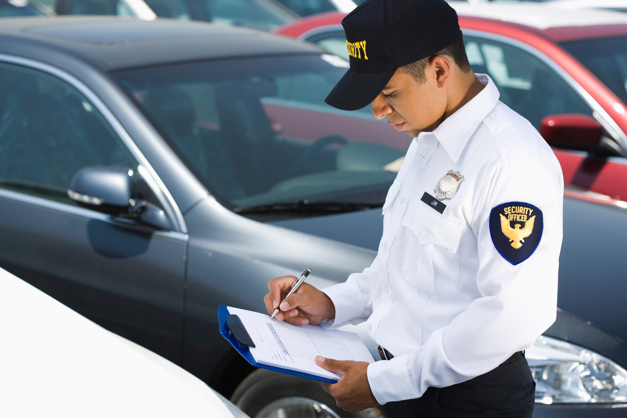 Security guard and cars in parking lot